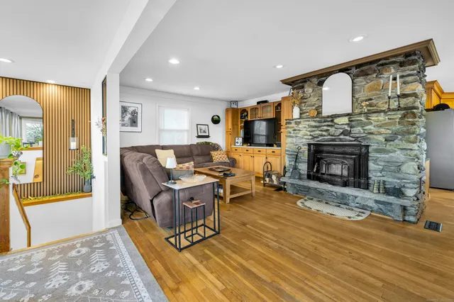 a living room with furniture and a fireplace