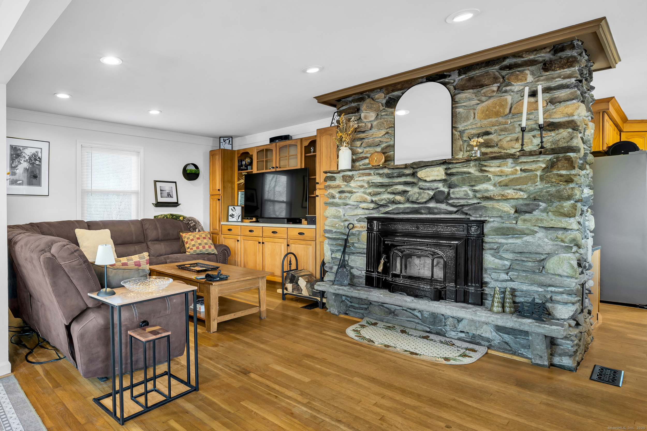 25 Cottage Grove Road Goshen, CT 06756 - Photo 14 of 38 a living room with furniture a fireplace and a flat screen tv