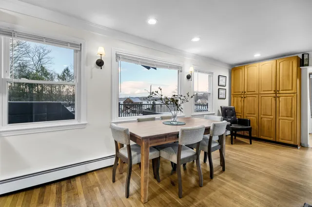 a view of a dining room with furniture window and wooden floor