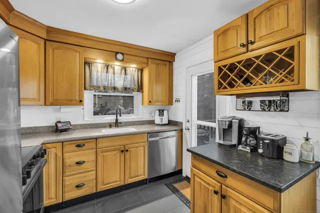 a kitchen with stainless steel appliances granite countertop a sink stove and cabinets