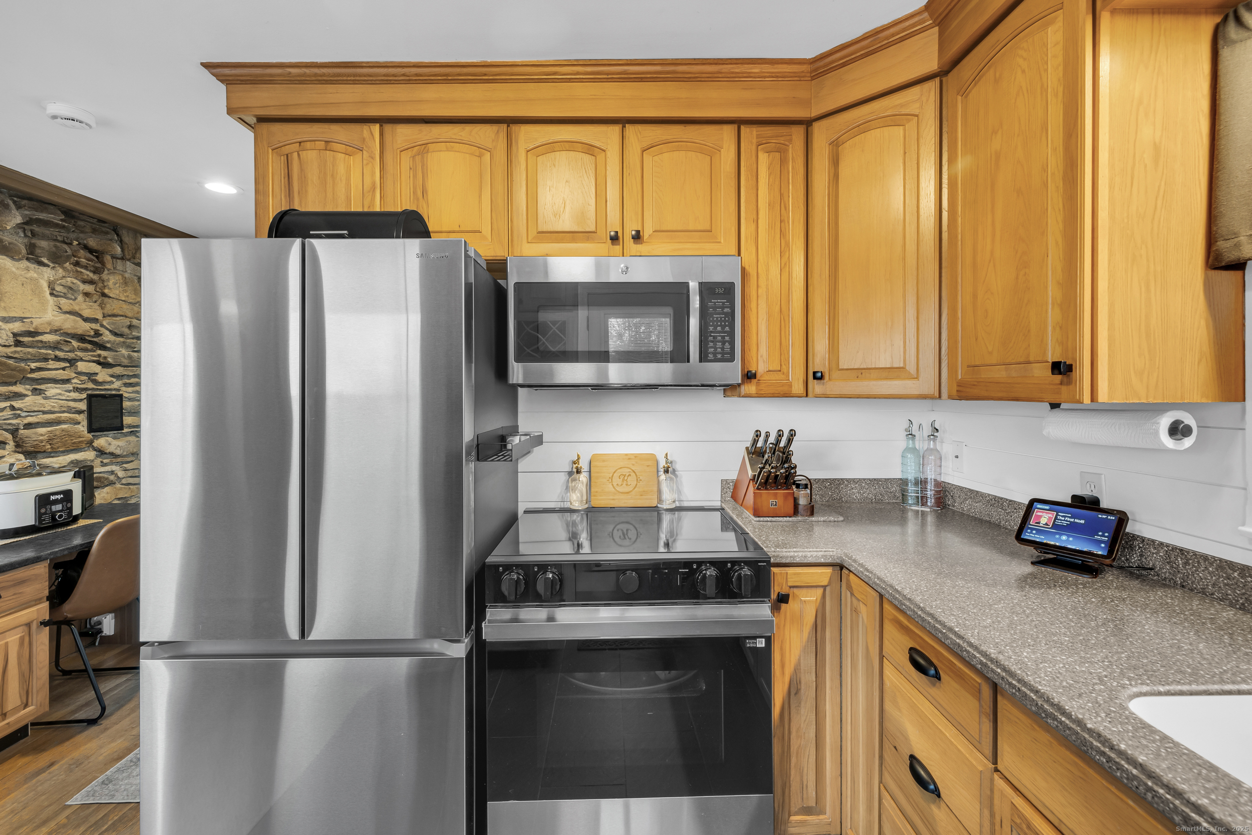 25 Cottage Grove Road Goshen, CT 06756 - Photo 19 of 38 a kitchen with a refrigerator and a stove top oven