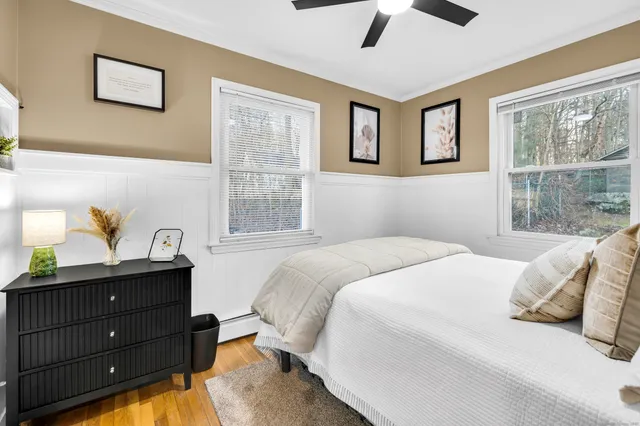 a bedroom with a bed and windows