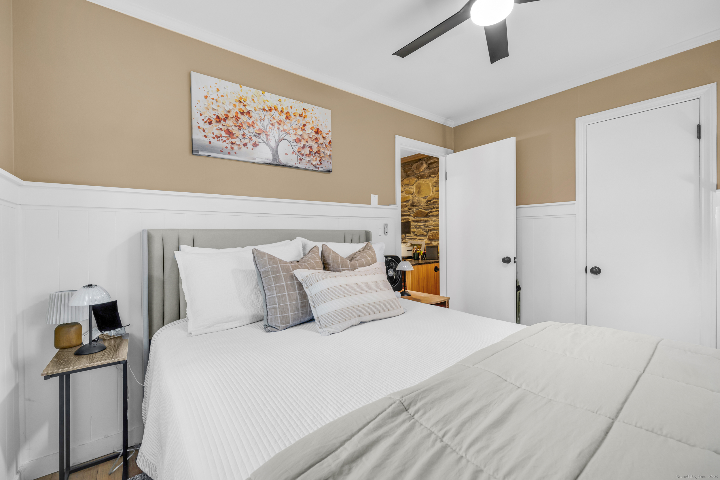 25 Cottage Grove Road Goshen, CT 06756 - Photo 21 of 38 a bedroom with a large bed and a chandelier