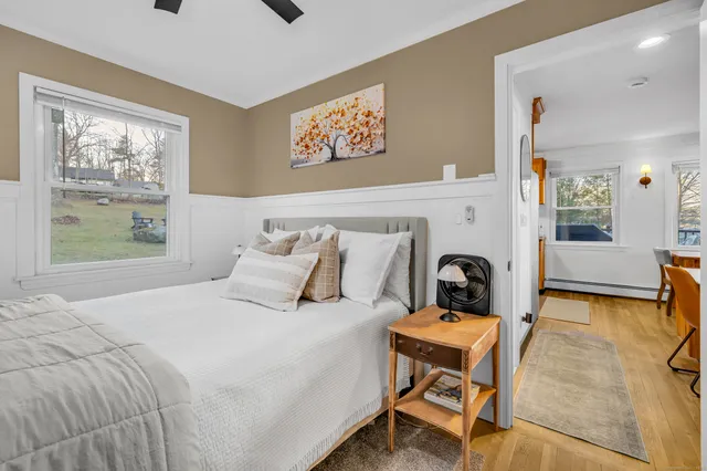 a bedroom with a bed and wooden floor