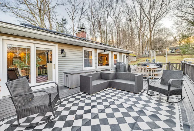a backyard of a house with barbeque oven table and chairs