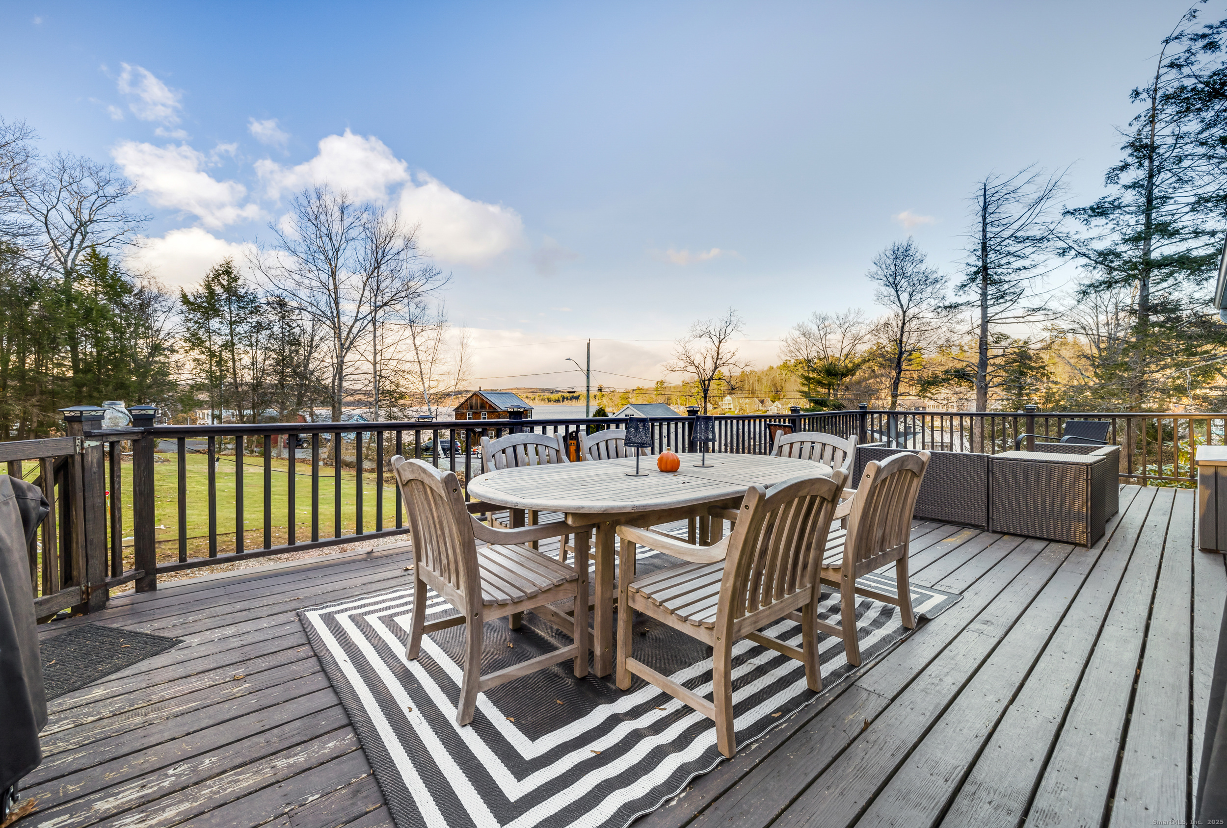 25 Cottage Grove Road Goshen, CT 06756 - Photo 27 of 38 a view of a roof deck with table and chairs a barbeque with wooden floor and fence