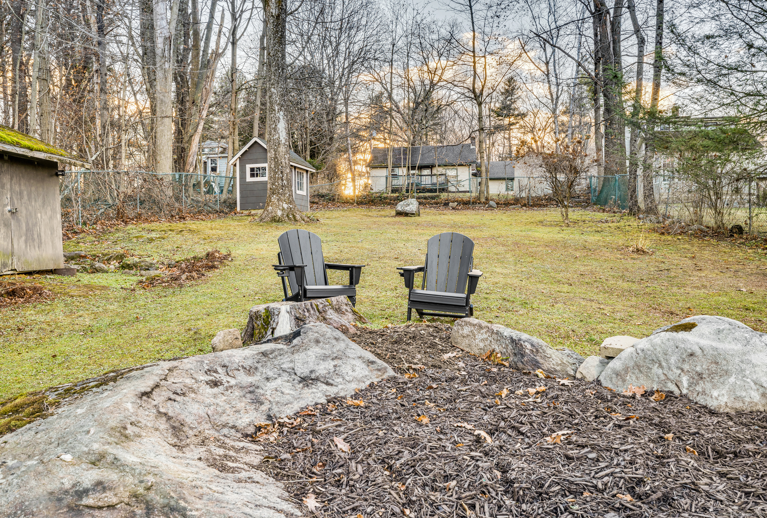 25 Cottage Grove Road Goshen, CT 06756 - Photo 28 of 38 a view of a lake with a bench and trees around