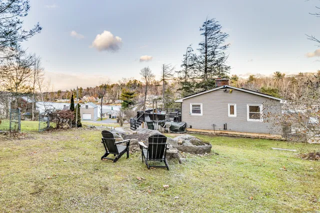 a swimming pool with outdoor seating and yard