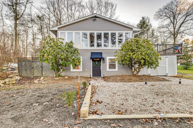 a front view of a house with a yard