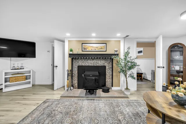 a living room with furniture a flat screen tv and a fireplace