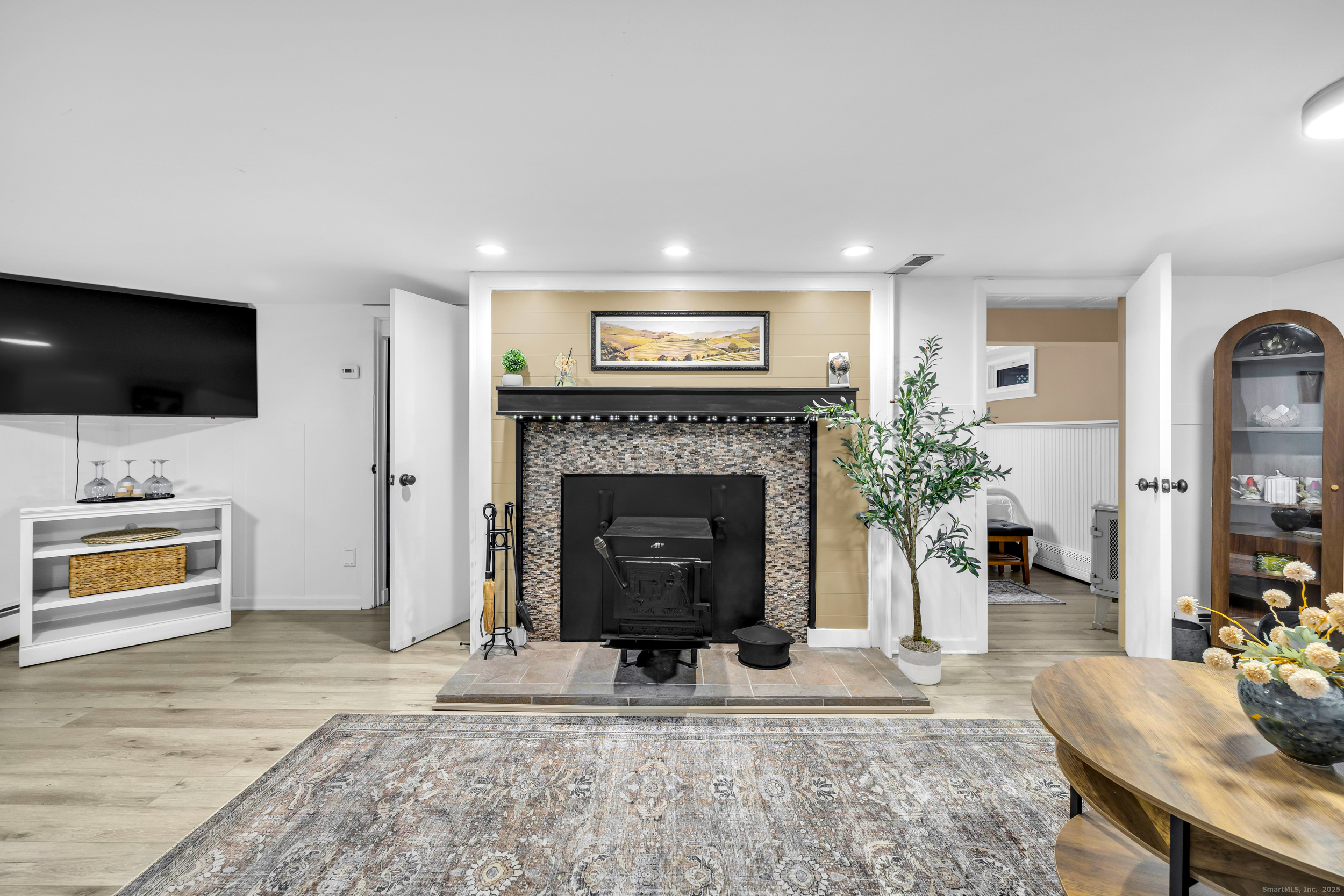 25 Cottage Grove Road Goshen, CT 06756 - Photo 4 of 38 a living room with furniture a flat screen tv and a fireplace