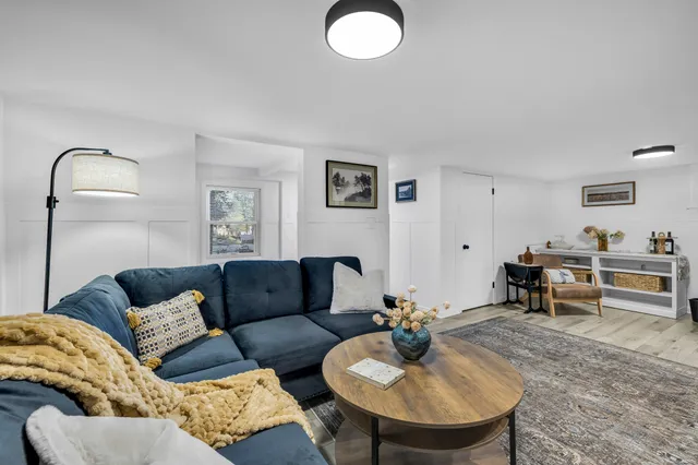 a living room with furniture and a mirror