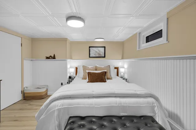 a bedroom with a bed and a lamp on table