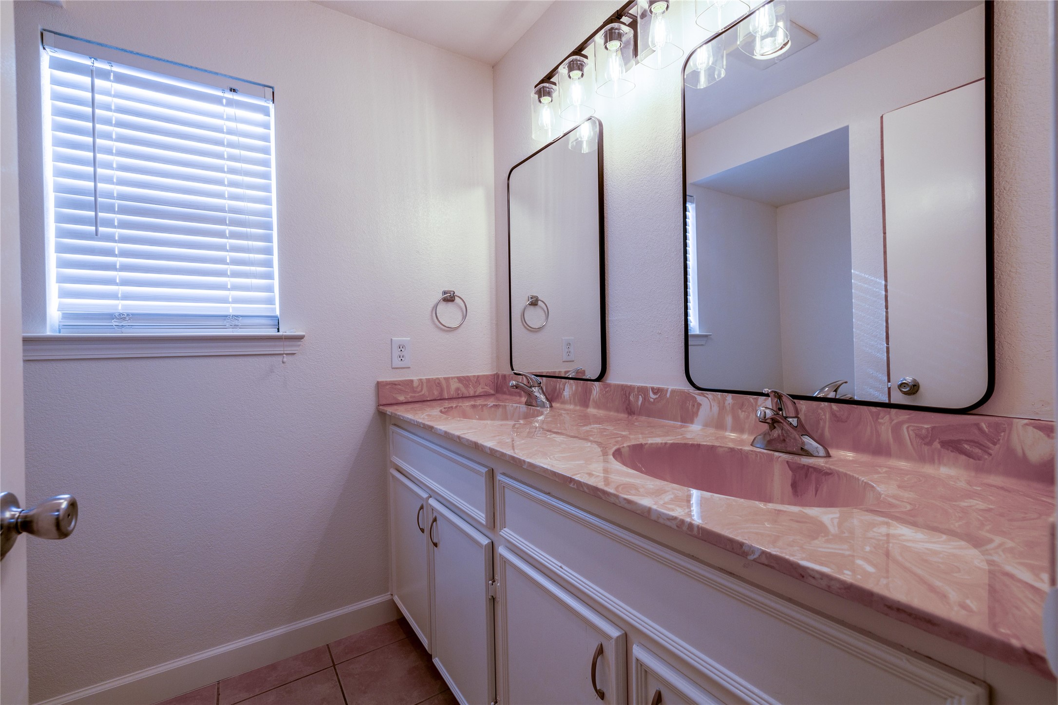 4304 Scottsdale Road Austin, TX 78721 - Photo 13 of 18 Bathroom with double vanity and light tile patterned floors