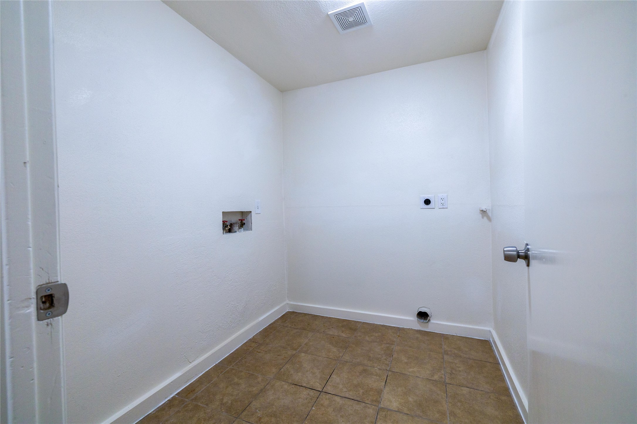 4304 Scottsdale Road Austin, TX 78721 - Photo 15 of 18 Laundry room with washer hookup, tile patterned floors, and electric dryer hookup