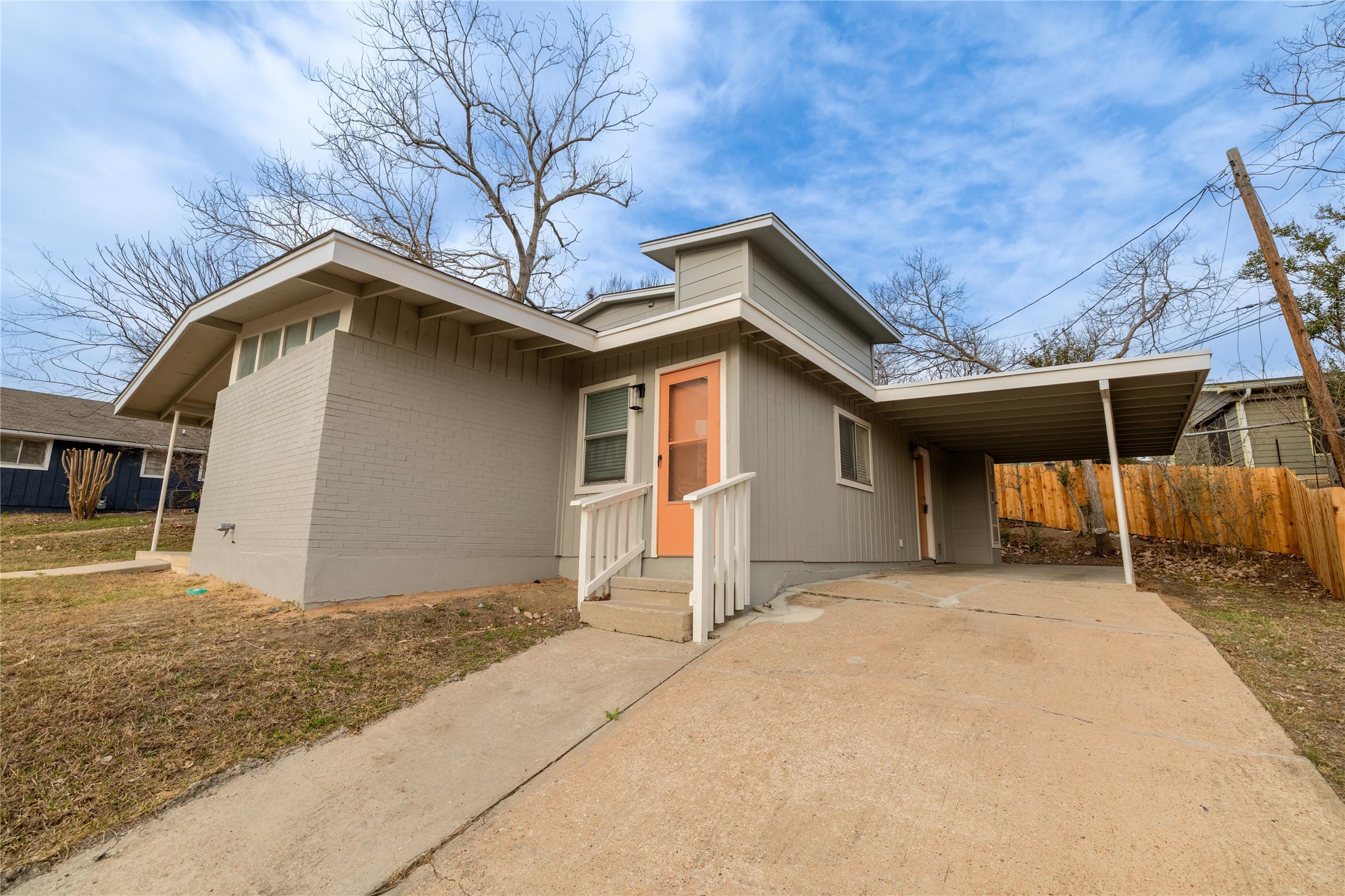 4304 Scottsdale Road Austin, TX 78721 - Photo 2 of 18 View of front of home with an attached carport, concrete driveway, and brick siding
