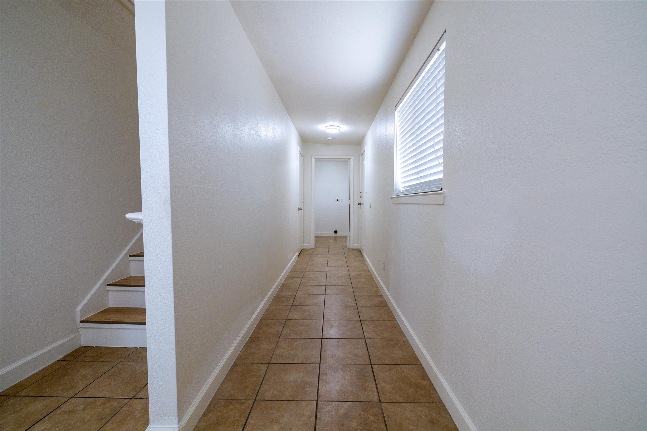 4304 Scottsdale Road Austin, TX 78721 - Photo 6 of 18 Corridor featuring light tile patterned floors and baseboards