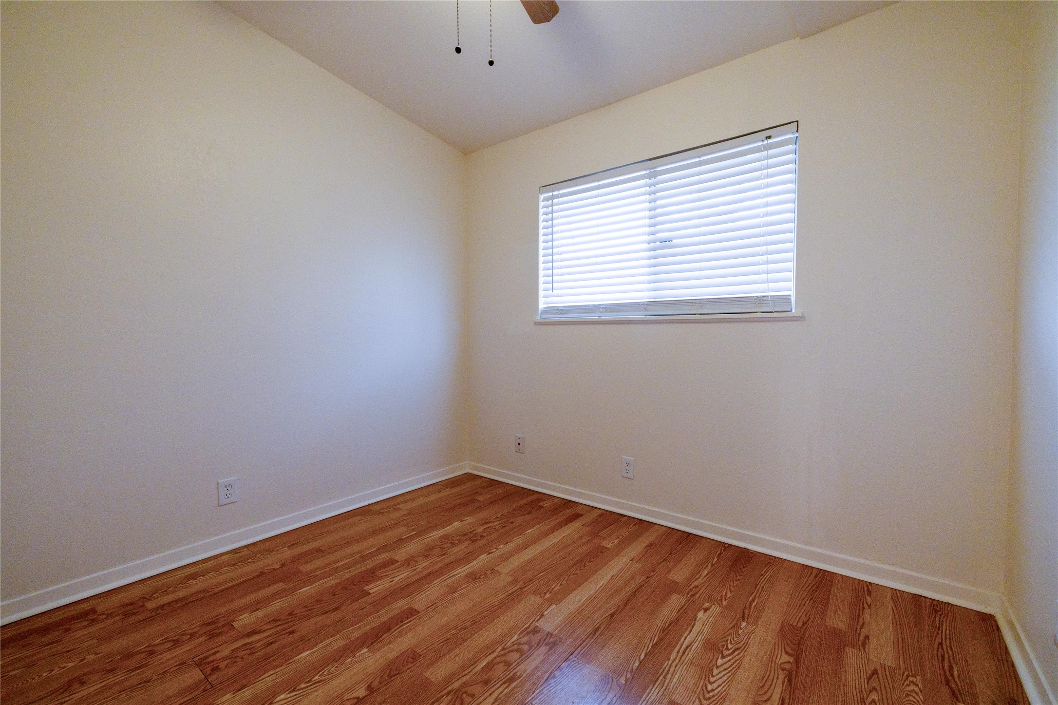 4304 Scottsdale Road Austin, TX 78721 - Photo 7 of 18 Spare room featuring light wood-type flooring, vaulted ceiling, and a ceiling fan