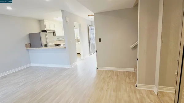 a view of a kitchen with wooden floor and a sink