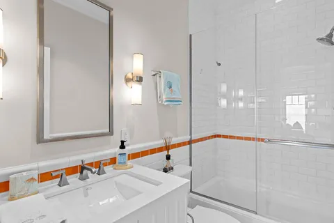 a bed room with a bed television and a large window