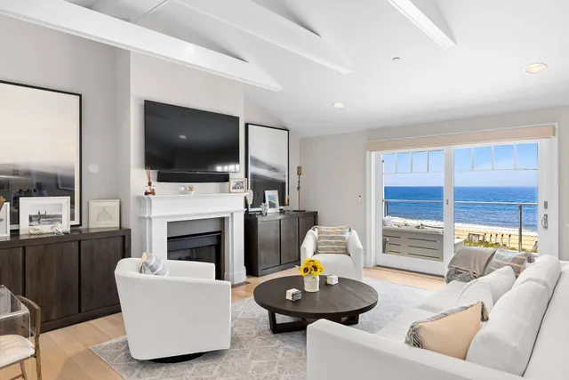 a living room with furniture and a dining table with kitchen view