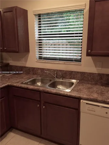 a kitchen with granite countertop a sink and a granite counter tops