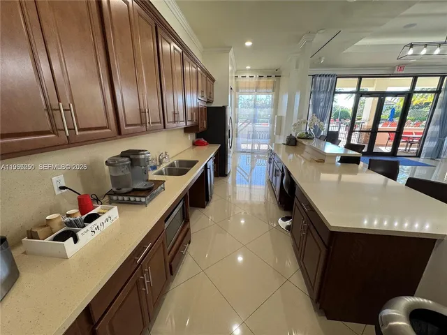 a kitchen with a stove a sink and a refrigerator