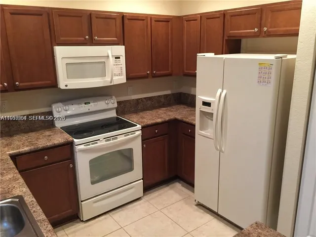 a kitchen with a stove and a microwave