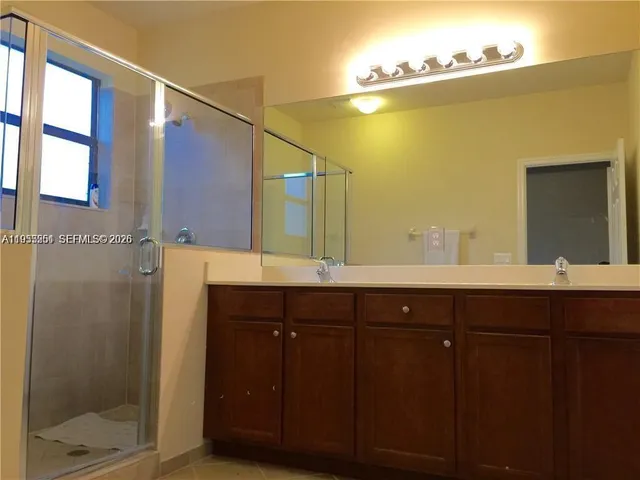 a bathroom with a double vanity sink and a mirror