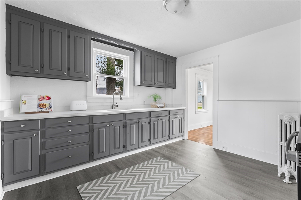 45 Ellsworth Road Peabody, MA 01960 - Photo 3 of 9 a kitchen with stainless steel appliances granite countertop a refrigerator a sink dishwasher and wooden cabinets with wooden floor