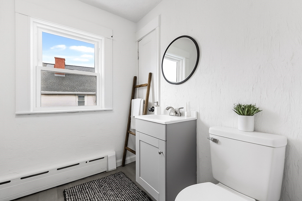 45 Ellsworth Road Peabody, MA 01960 - Photo 6 of 9 a bathroom with a toilet a sink and a mirror