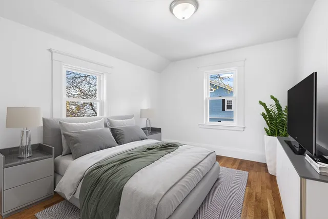 a bedroom with a large bed and a flat screen tv