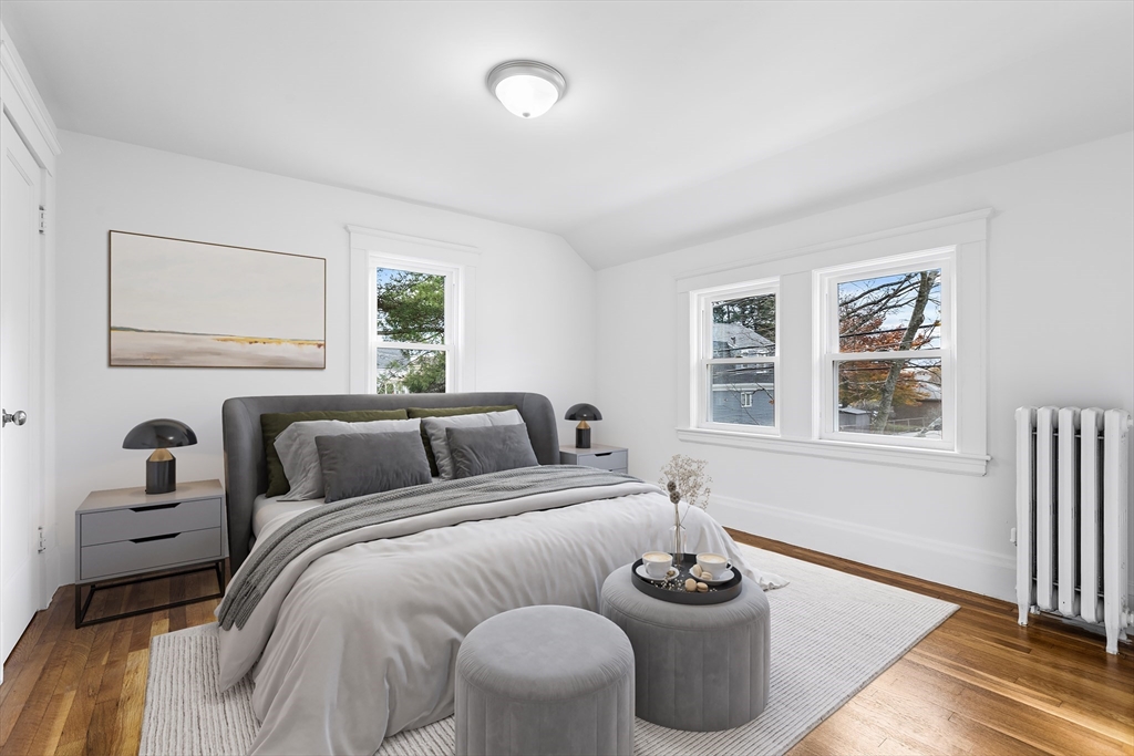 45 Ellsworth Road Peabody, MA 01960 - Photo 8 of 9 a bedroom with a bed and a large mirror