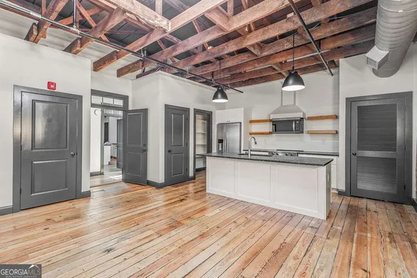 a view of a kitchen with stainless steel appliances granite countertop a refrigerator and a sink