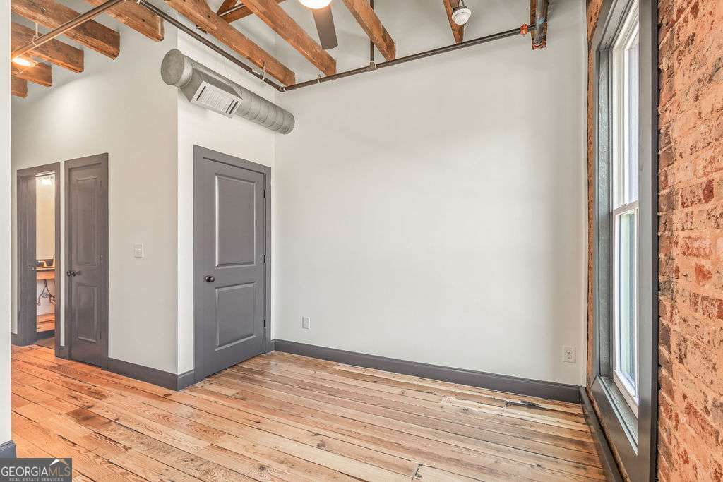 13 Greenville Street South, Unit B Newnan, GA 30263 - Photo 14 of 16 a view of a hallway with wooden floor and a bathroom