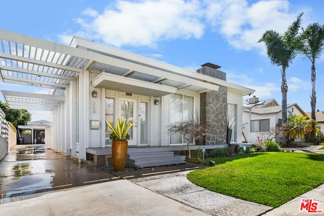 a view of house with outdoor seating area