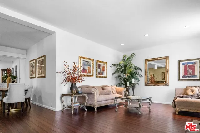 a living room with furniture or wooden floor and a potted plant