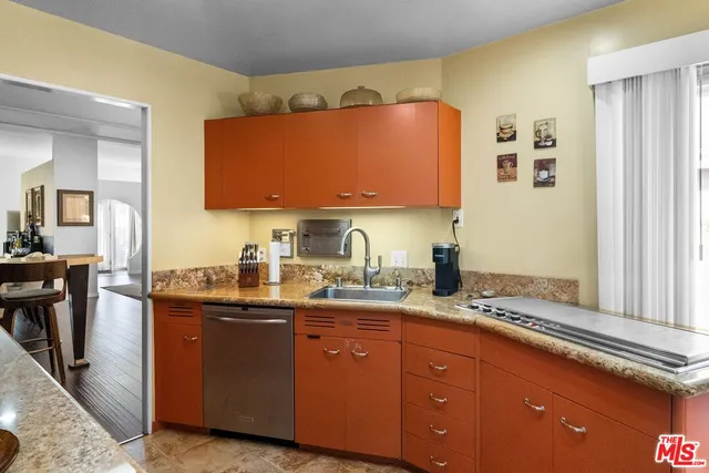 a kitchen with stainless steel appliances granite countertop a sink and cabinets