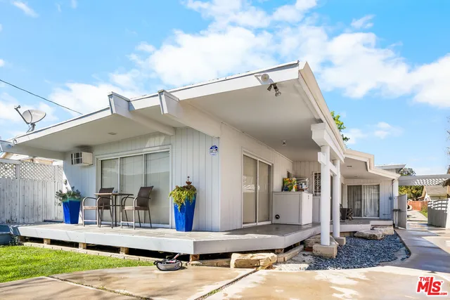 a view of a patio with table and chairs