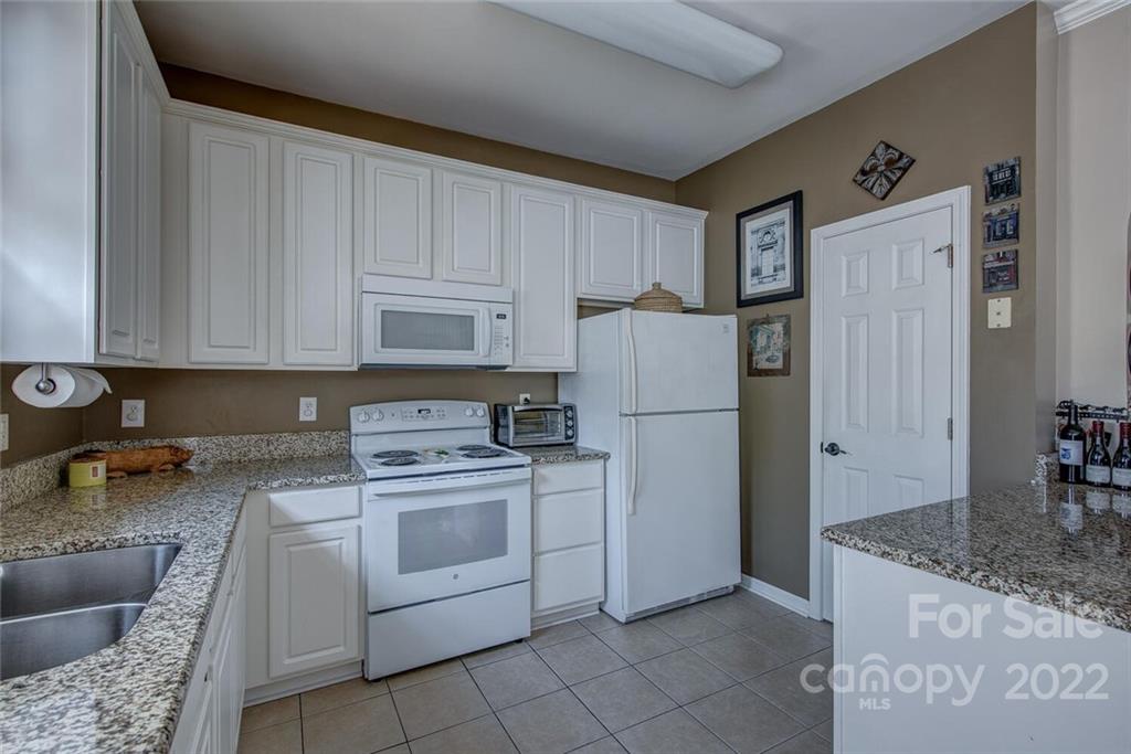 909 Azurine Circle Fort Mill, SC 29708 - Photo 18 of 30 a kitchen with a refrigerator sink and cabinets
