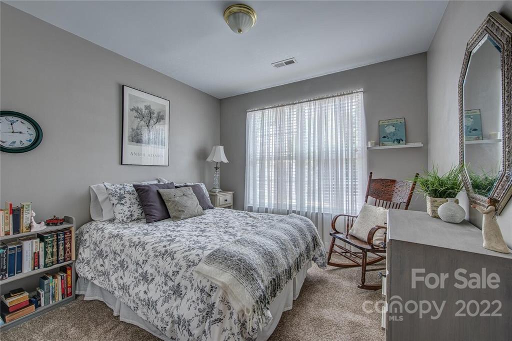 909 Azurine Circle Fort Mill, SC 29708 - Photo 27 of 30 a bedroom with a bed a bookshelf and a window