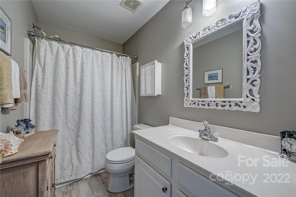 909 Azurine Circle Fort Mill, SC 29708 - Photo 28 of 30 a bathroom with a granite countertop sink toilet and mirror