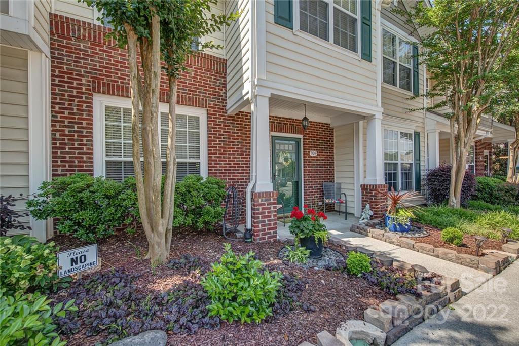 909 Azurine Circle Fort Mill, SC 29708 - Photo 3 of 30 a view of a house with potted plants and a table and chairs