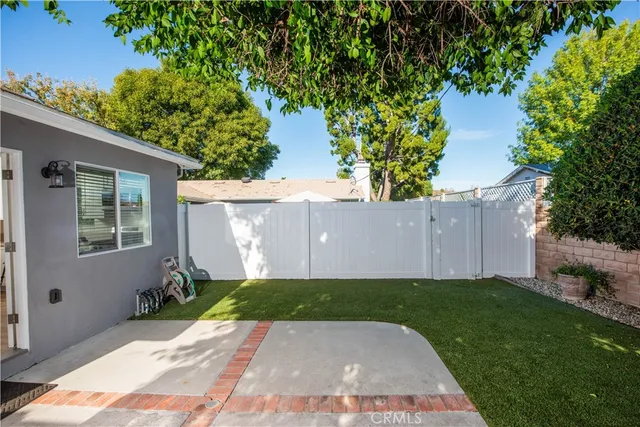 a view of an house with backyard space and garden