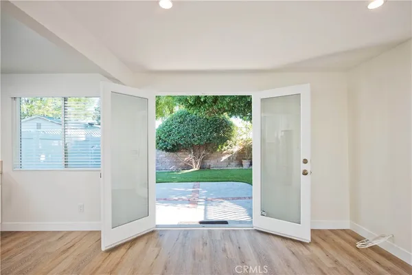 a kitchen with cabinets stainless steel appliances and wooden floor