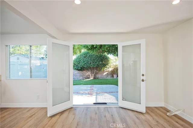 a kitchen with cabinets stainless steel appliances and wooden floor