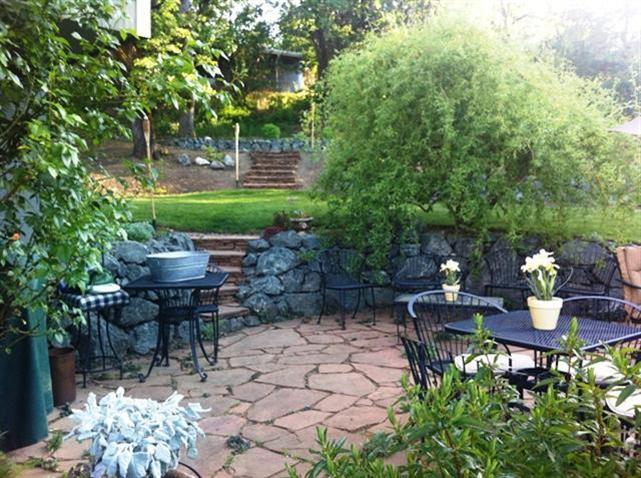 3155 Old Stage Road Central Point, OR 97502 - Photo 7 of 24 a backyard view with table and chairs potted plants and large tree