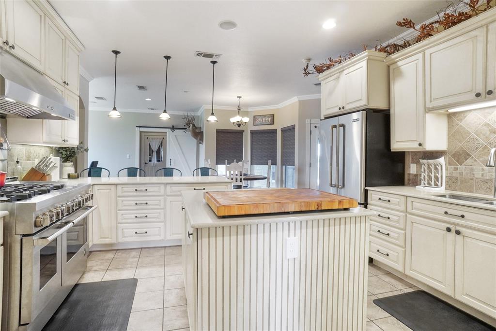 13340 John Day Road Haslet, TX 76052 - Photo 9 of 30 a kitchen with stainless steel appliances kitchen island granite countertop a sink and cabinets