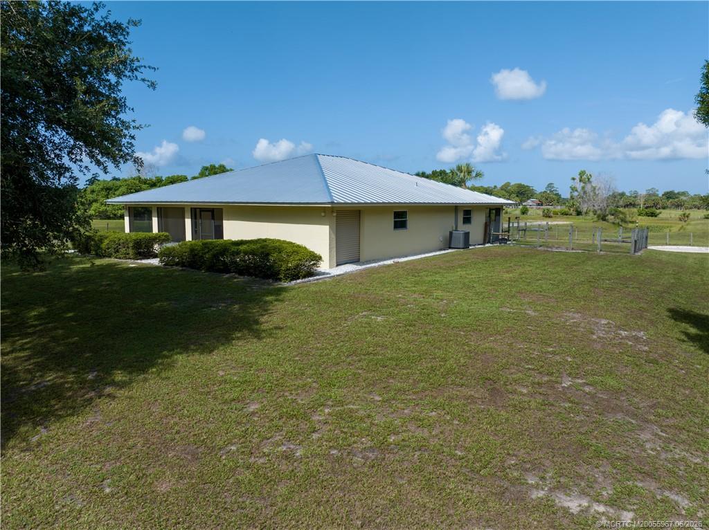 8200 Southwest Springhaven Avenue Indiantown, FL 34956 - Photo 14 of 35 a front view of a house with garden