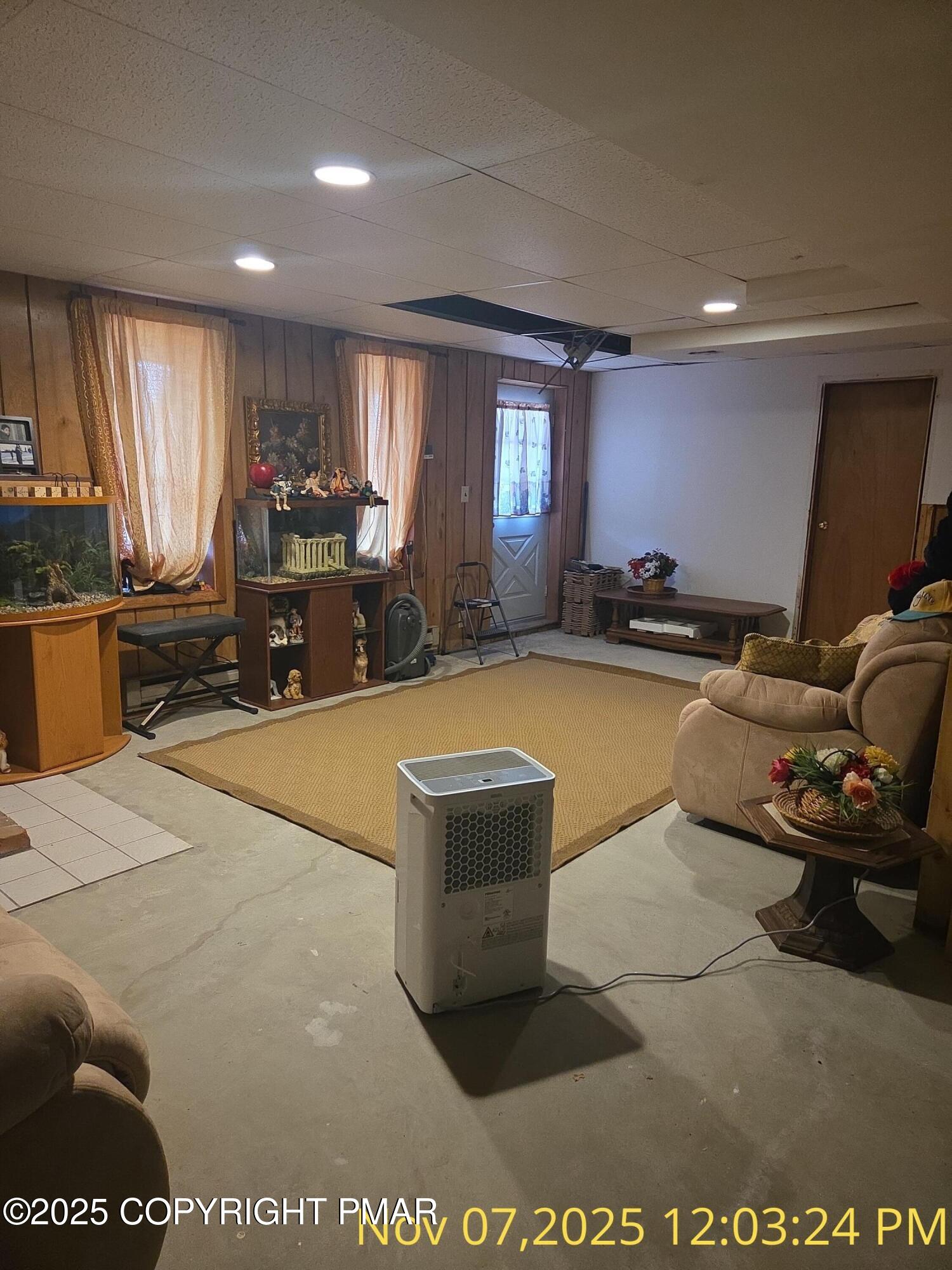 1107 Hampstead Road Bushkill, PA 18324 - Photo 11 of 20 a living room with furniture a large window and gym equipment
